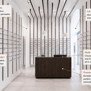 45° oblique view linear frame display wall vertical slat optical panel central wood optician counter feature labels