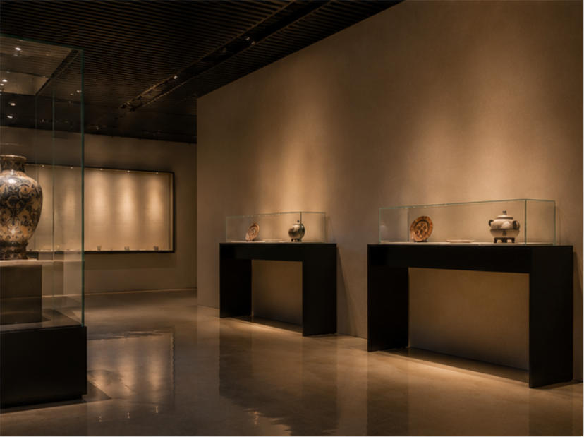 Open-frame artifact display case in museum setting
