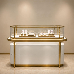 Curved Glass Jewelry Counter | Gold Frame Showcase - Sunzen 2 Curved glass jewelry counter with gold frame, lit base, and enclosed display