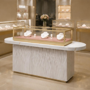 Fluted Base Jewelry Counter | Marble Top Gold Frame Glass Showcase - Sunzen 3 Fluted base marble top gold glass jewelry counter placed inside light luxury boutique