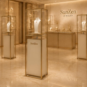 Open Gold Frame Pedestal | Raised Inner Display Shelf Vertical Beige Base Unit Ceiling Dot Spot Booth Single Necklace Display Tower 6 On-site render open gold frame pedestal single necklace display tower placed as window focal landmark inside minimalist luxury jewelry flagship boutique