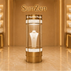 Cylindrical Pearl Tower | Rotatable Floor Kiosk Brass Round Vitrine - Sunzen 3 Full front render rotatable floor kiosk cylindrical pearl tower full 360 transparent glass cylinder branded brass top plinth for single pearl necklace focal display