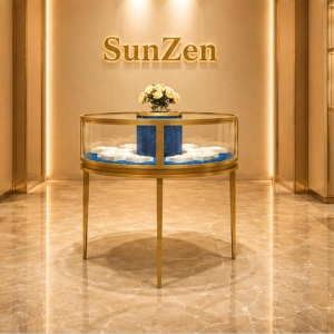 Round Jewel Island | Gold Glass Circular Display Booth - Sunzen 3 Full front render single round jewel island gold glass circular display booth with built-in floral decor center for boutique central zone