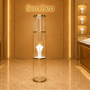 Tall Cylinder Jewelry Tower | Gold Rim Glass Pedestal Vertical Round Vitrine – Sunzen Display 3 Front real shot of tall cylinder jewelry tower slim floor display stand single necklace plinth inside Sunzen luxury jewelry boutique