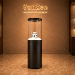 Front real shot of cylindrical vase vitrine single pottery exhibit tower round pedestal museum stand inside Sunzen porcelain heritage museum exhibition hall
