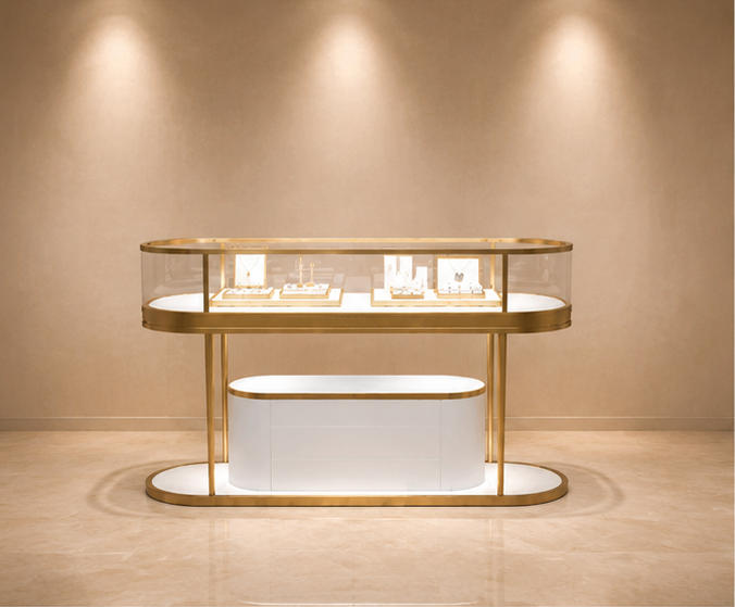 Oval two-tier central jewelry island with gold curved glass drawer base