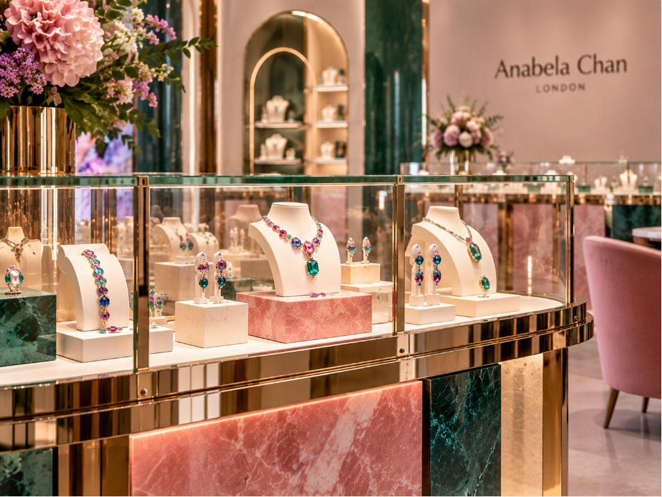 Jewelry display fixture detail with colored stone mirrored metal and acrylic